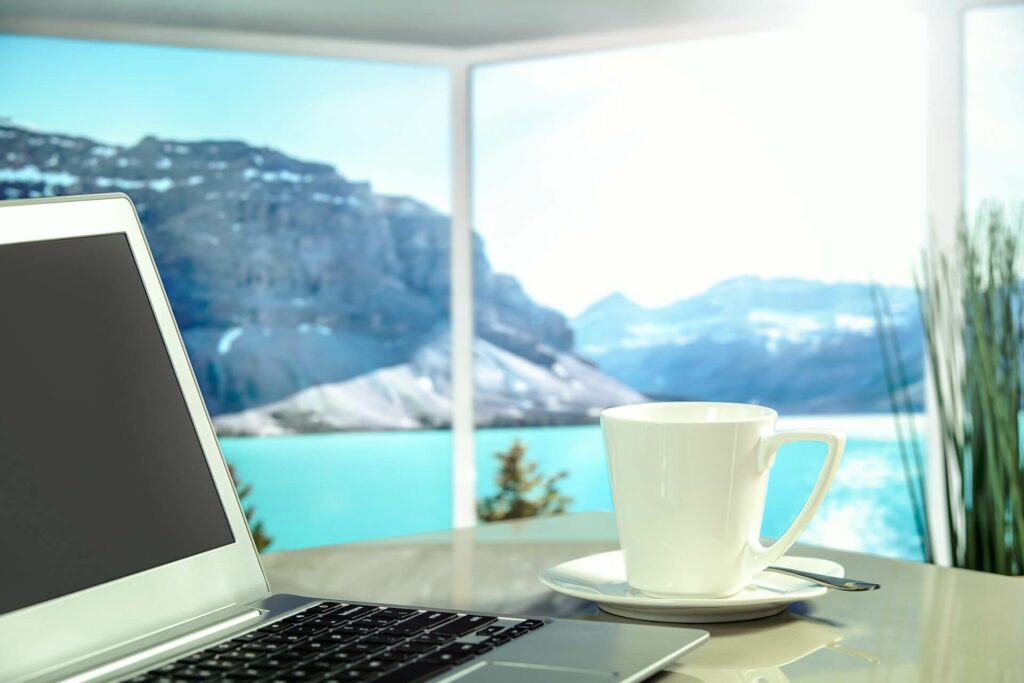table with laptop lake and mountain view, contact Officiency, small business bookkeeping Newsletter